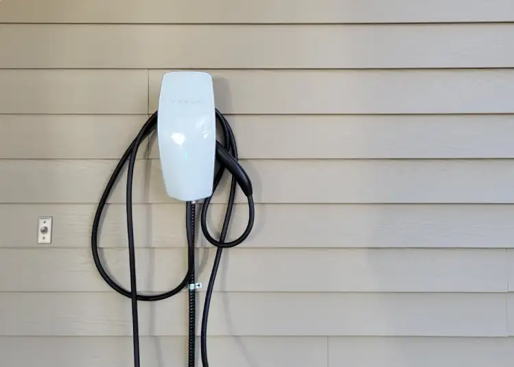 An electric vehicle charging at a public fast charging station for a quick charge on the go.